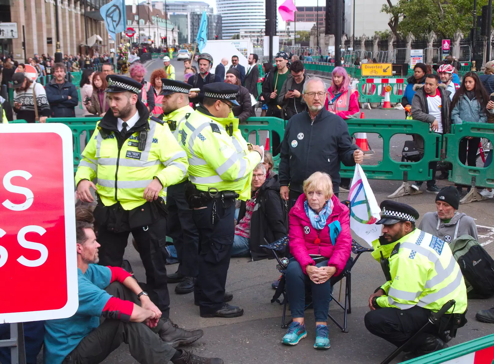 A worried-looking woman is talked to by the rozzers, from The Extinction Rebellion Protest, Westminster, London - 9th October 2019