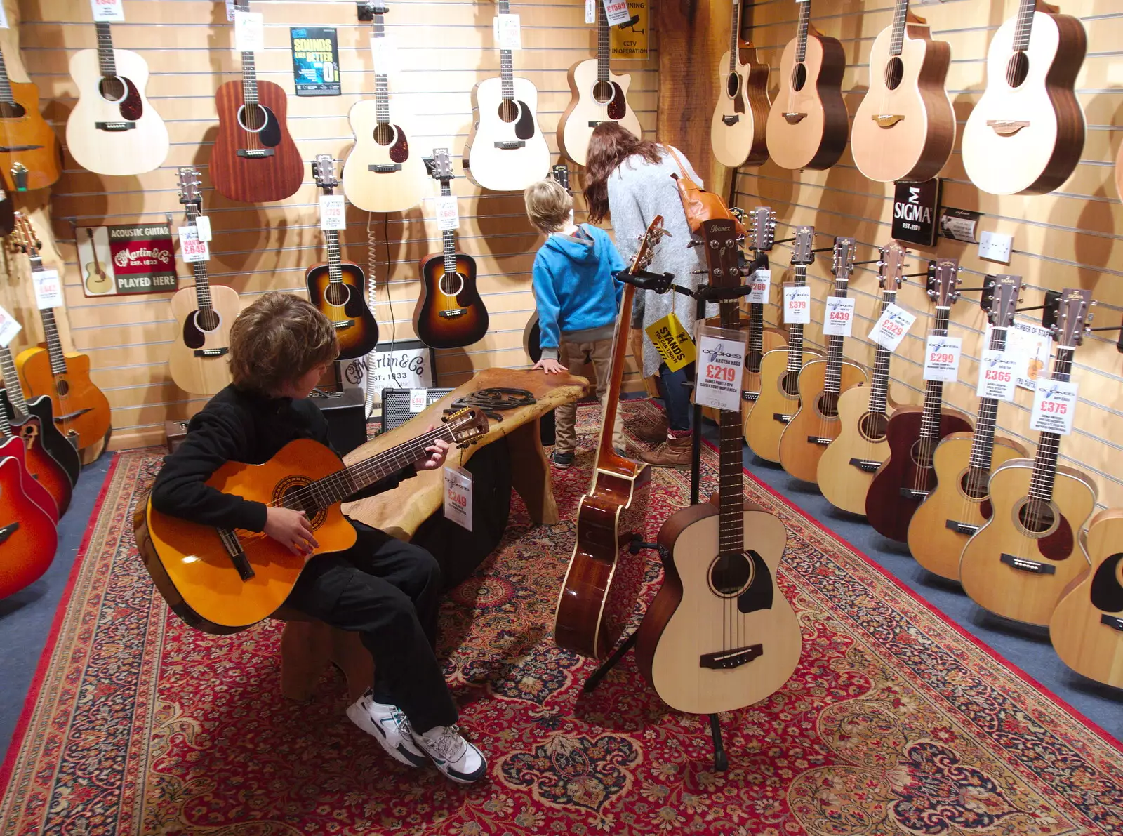 Fred and Harry try guitars in Cooke's, from A Trip up the Big City, Norwich, Norfolk - 18th October 2019