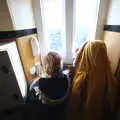 The boys peer out of a small window, A Trip up a Lighthouse, Southwold, Suffolk - 27th October 2019