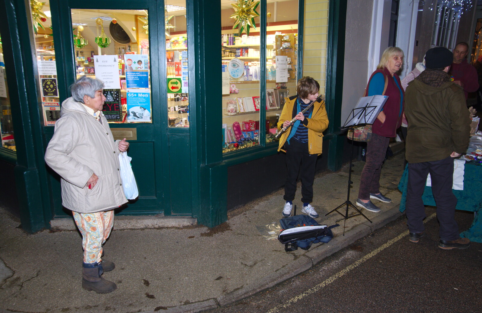 Fred does flute outside the pharmacy from Isobel Sings at the Eye Lights, Eye, Suffolk - 28th November 2019
