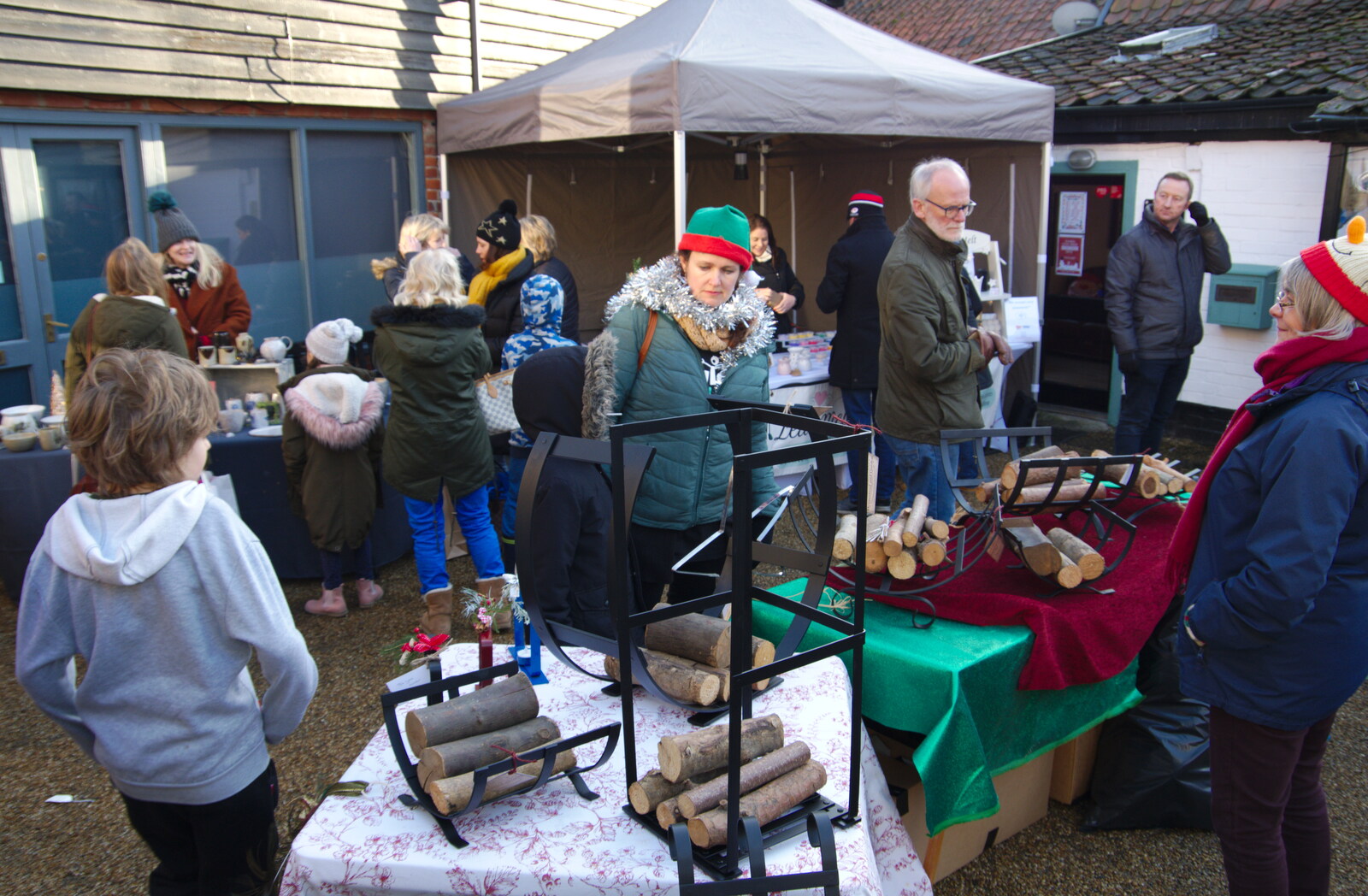 Isobel peruses log holders from The St. Nicholas Street Winter Fayre, Diss, Norfolk - 14th December 2019