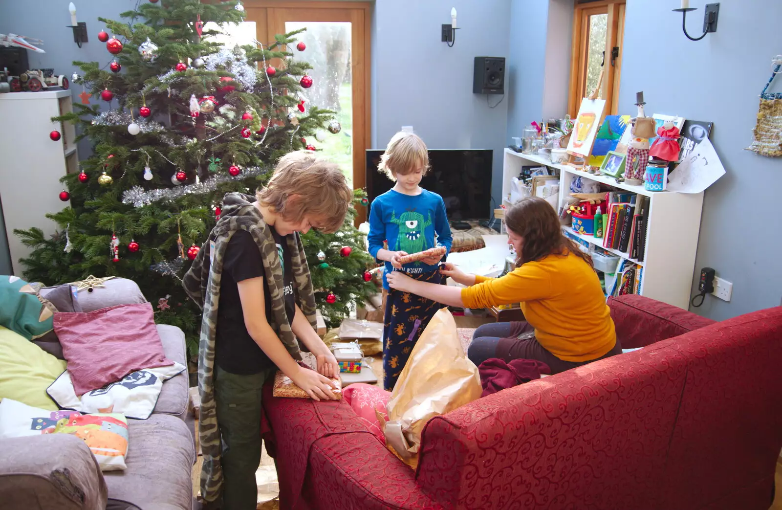 Fred and Harry open an early present each, from A Christingle Service, St. Nicholas Church, Oakley, Suffolk - 24th December 2019