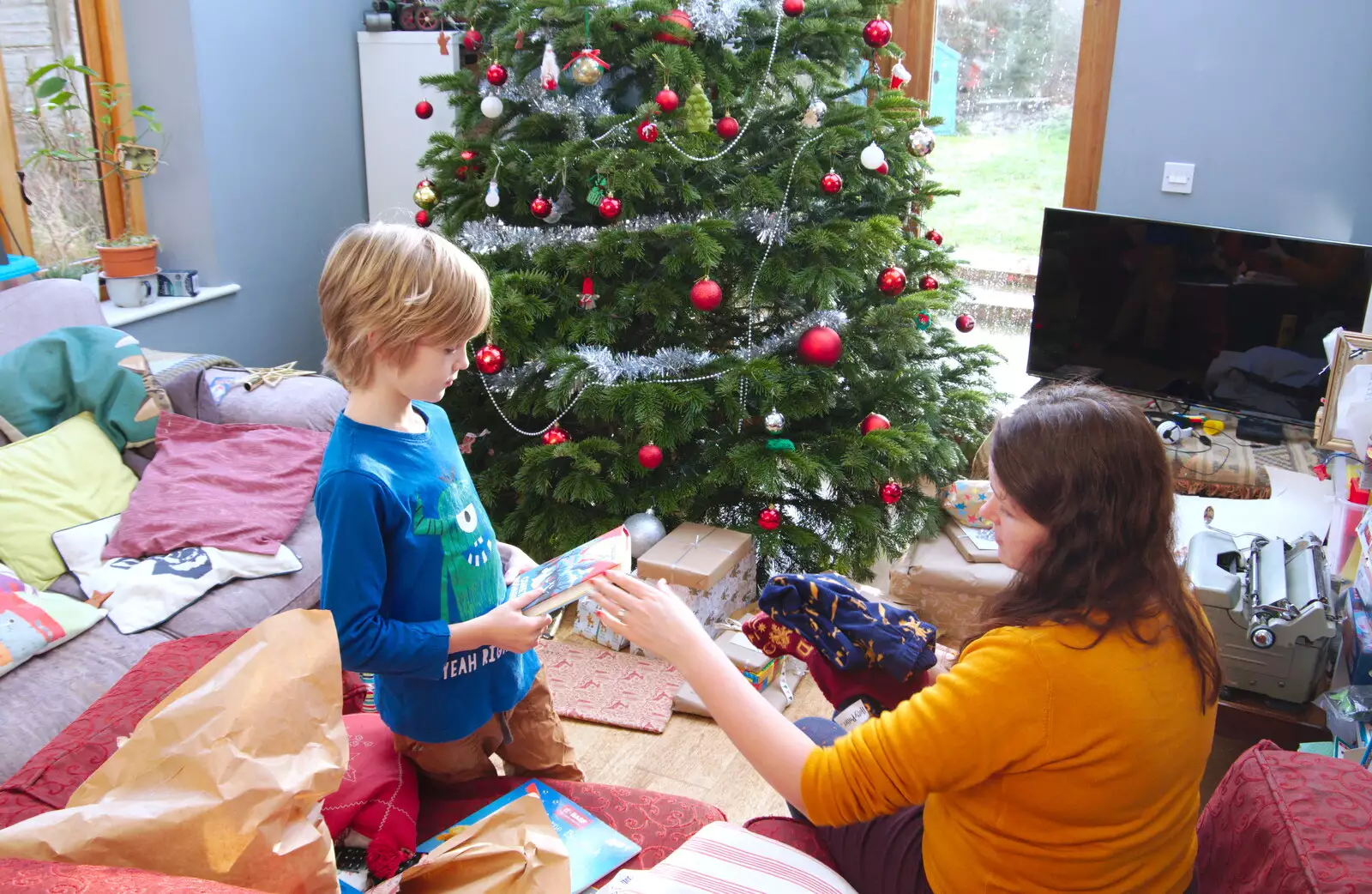 Harry's got a Christmasaurus book, from A Christingle Service, St. Nicholas Church, Oakley, Suffolk - 24th December 2019