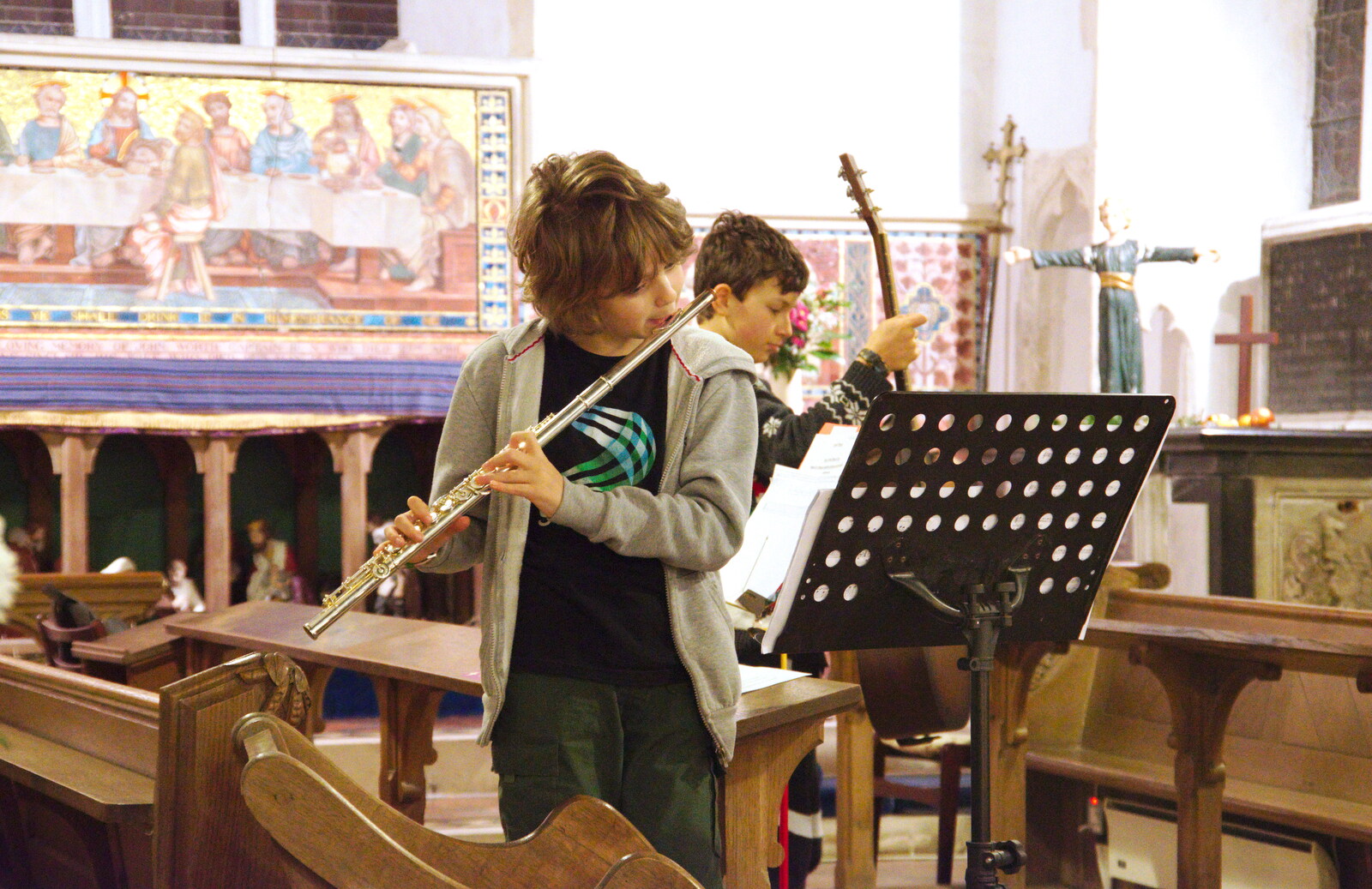Fred blows on his flute from A Christingle Service, St. Nicholas Church, Oakley, Suffolk - 24th December 2019