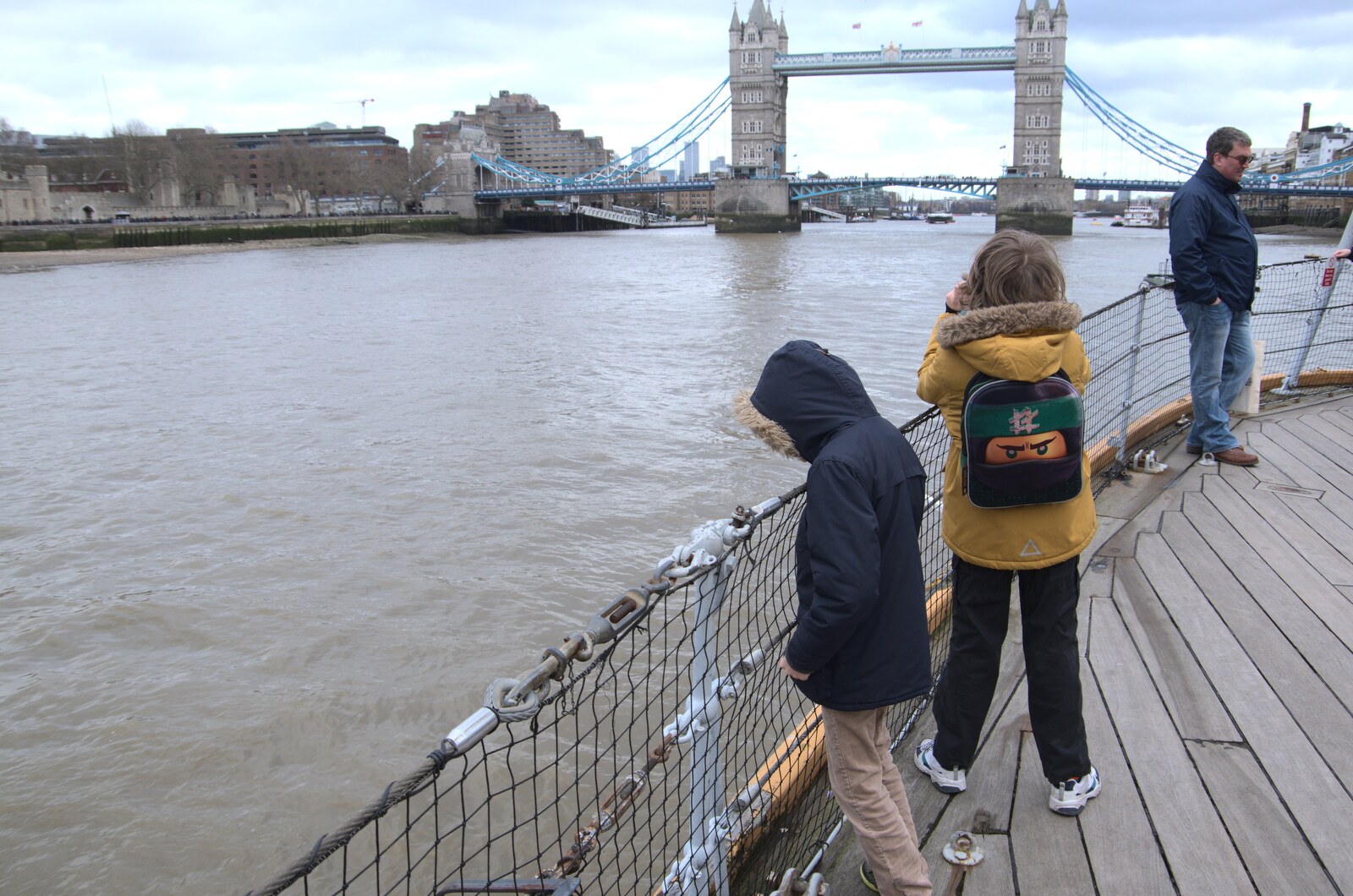 Harry peers into the Thames from HMS Belfast and the South Bank, Southwark, London - 17th February 2020