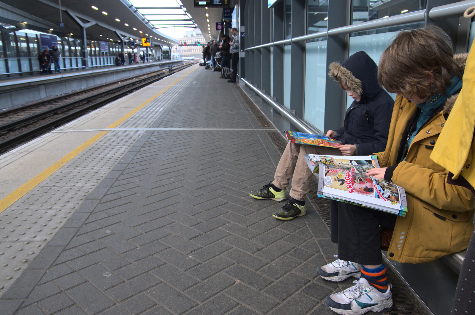 The boys read magazines as we wait for our train from HMS Belfast and the South Bank, Southwark, London - 17th February 2020