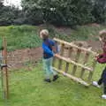 The boys carry off a pallet, An April Lockdown Miscellany, Eye, Suffolk - 10th April 2020