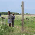 Isobel reads one of the airfield information boards, The Quest for Rapsy Tapsy Lane, Eye, Suffolk - 6th May 2020