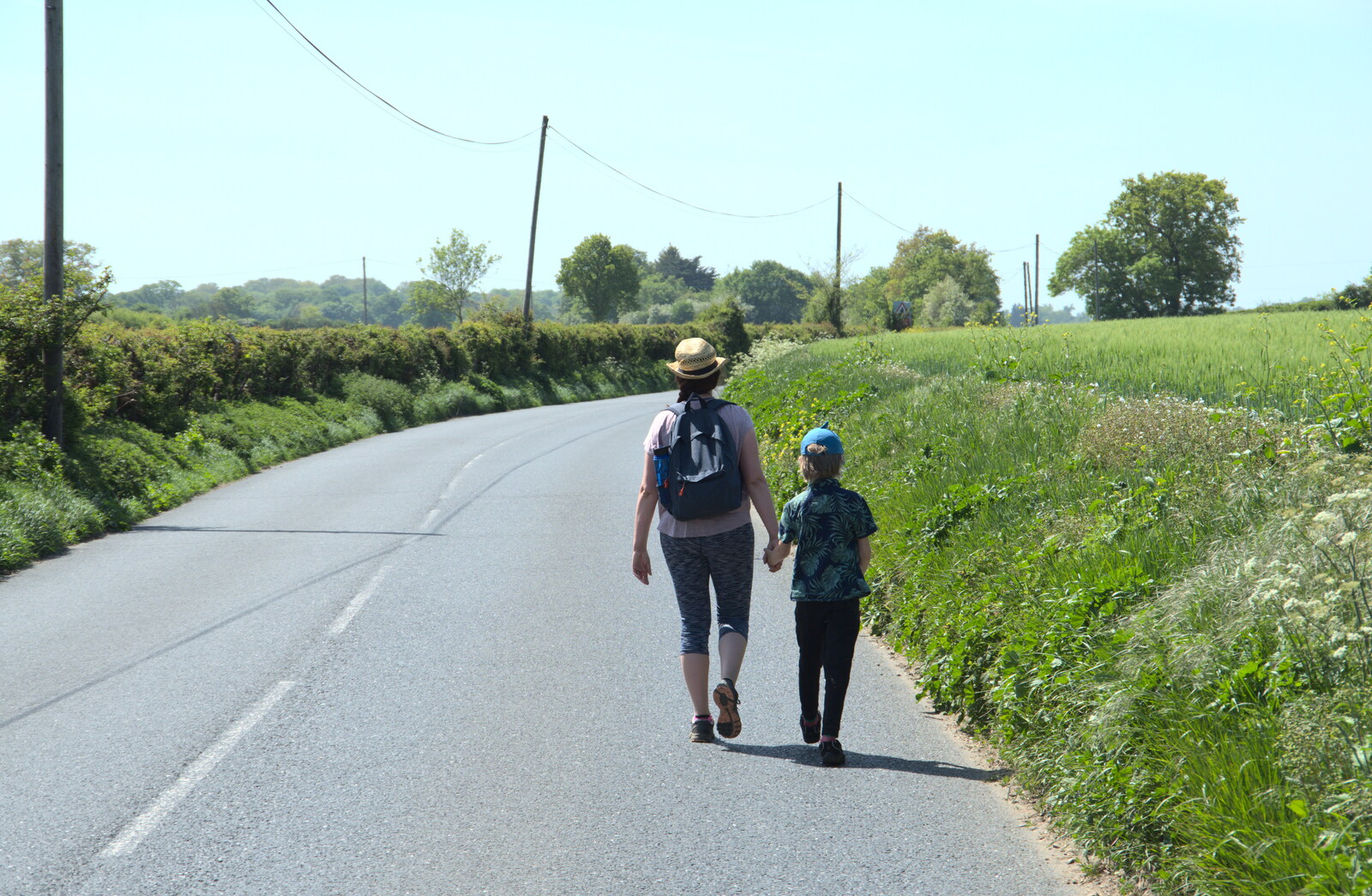 Isobel and Harry walk down the road from A Walk up Rapsy Tapsy Lane, Eye, Suffolk - 9th May 2020