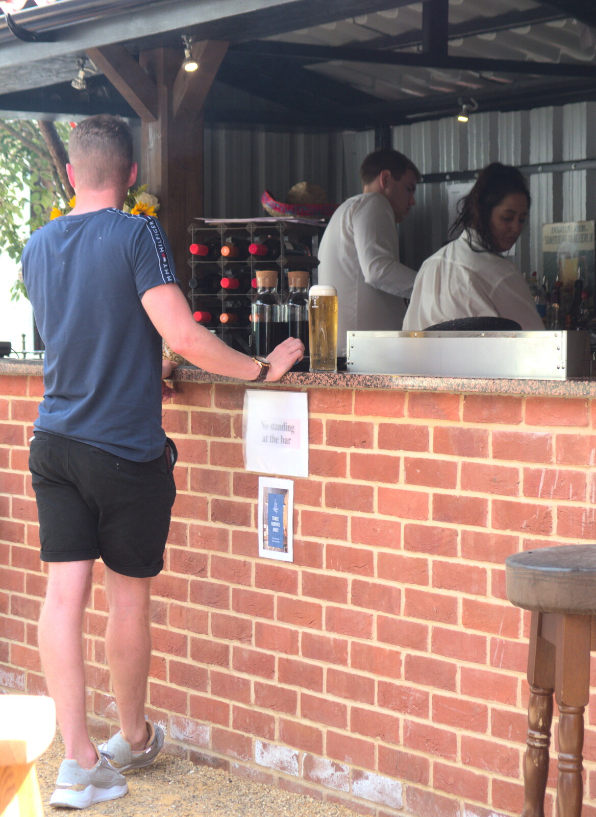 A dude stands by the 'no standing at the bar' sign from The BSCC at Redgrave and Station 119, Eye, Suffolk - 17th July 2020