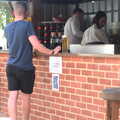 A dude stands by the 'no standing at the bar' sign, The BSCC at Redgrave and Station 119, Eye, Suffolk - 17th July 2020