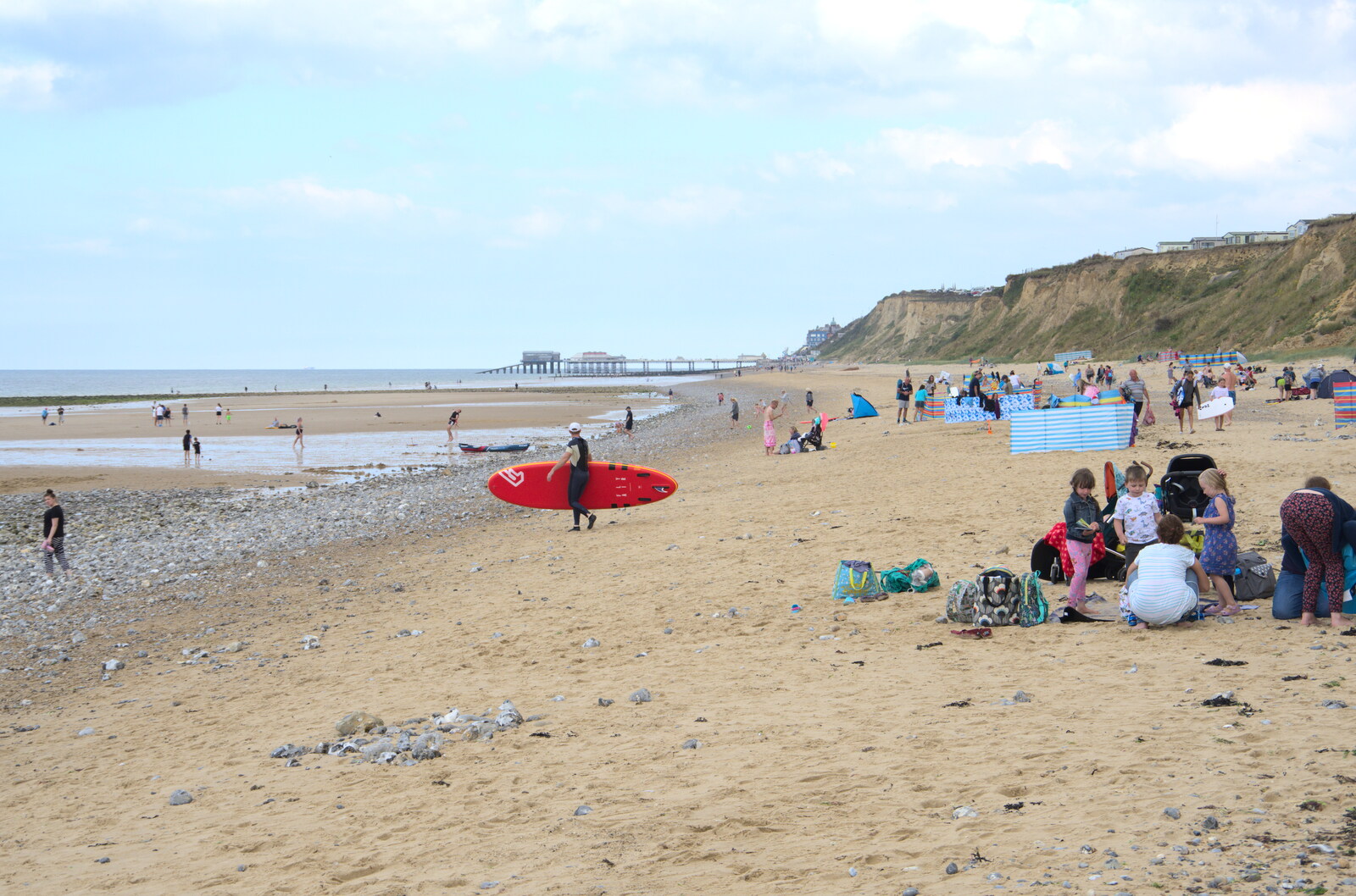 A surfer hauls out to sea from Camping on the Coast, East Runton, North Norfolk - 25th July 2020