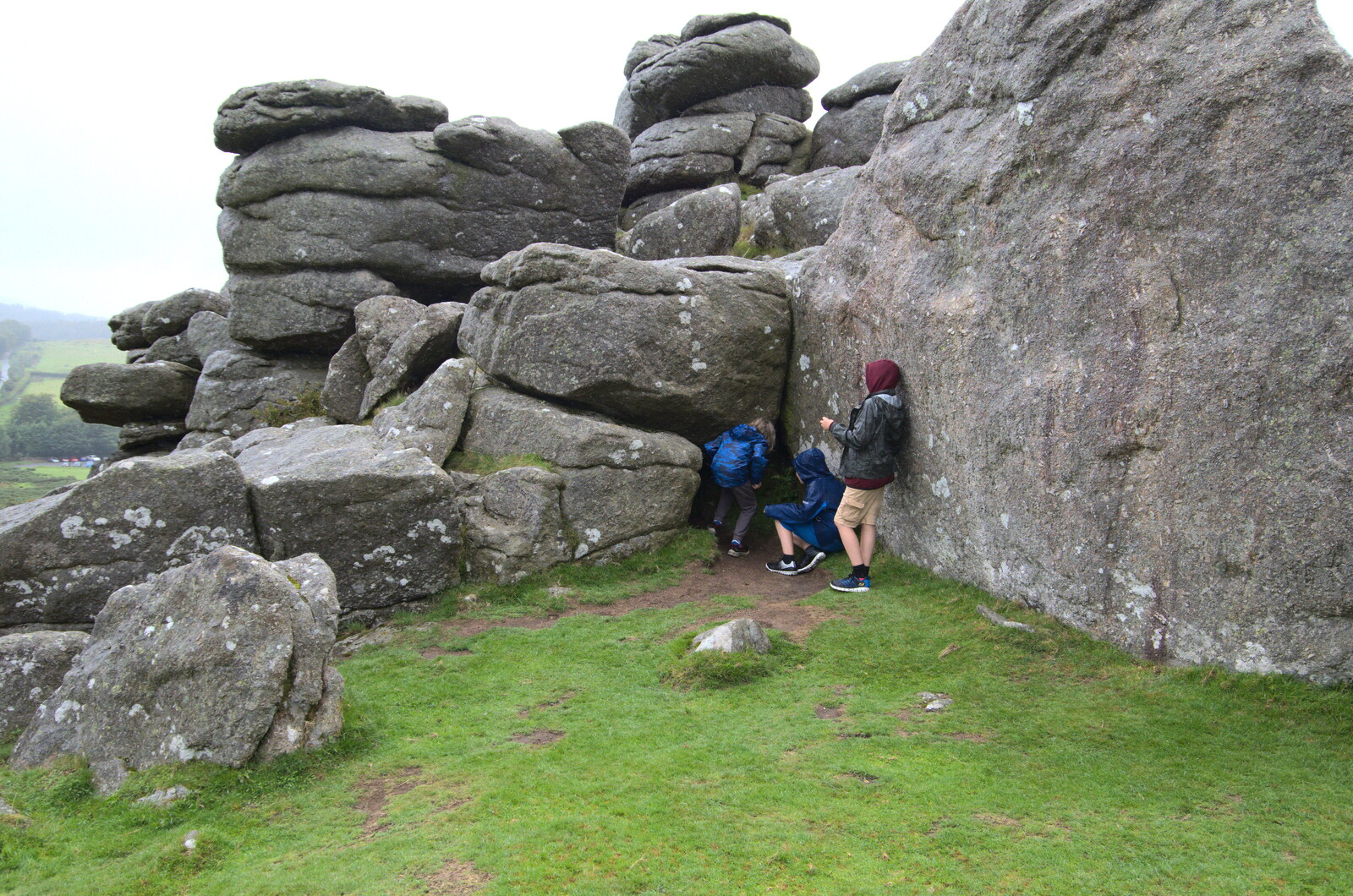 The boys inspect a cave from A Walk up Hound Tor, Dartmoor, Devon - 24th August 2020