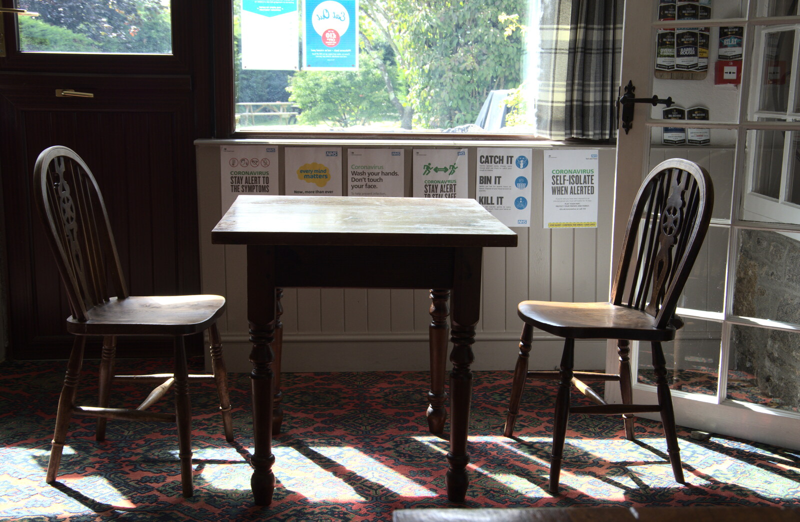 An empty table and a range of Covid posters from A Walk up Hound Tor, Dartmoor, Devon - 24th August 2020