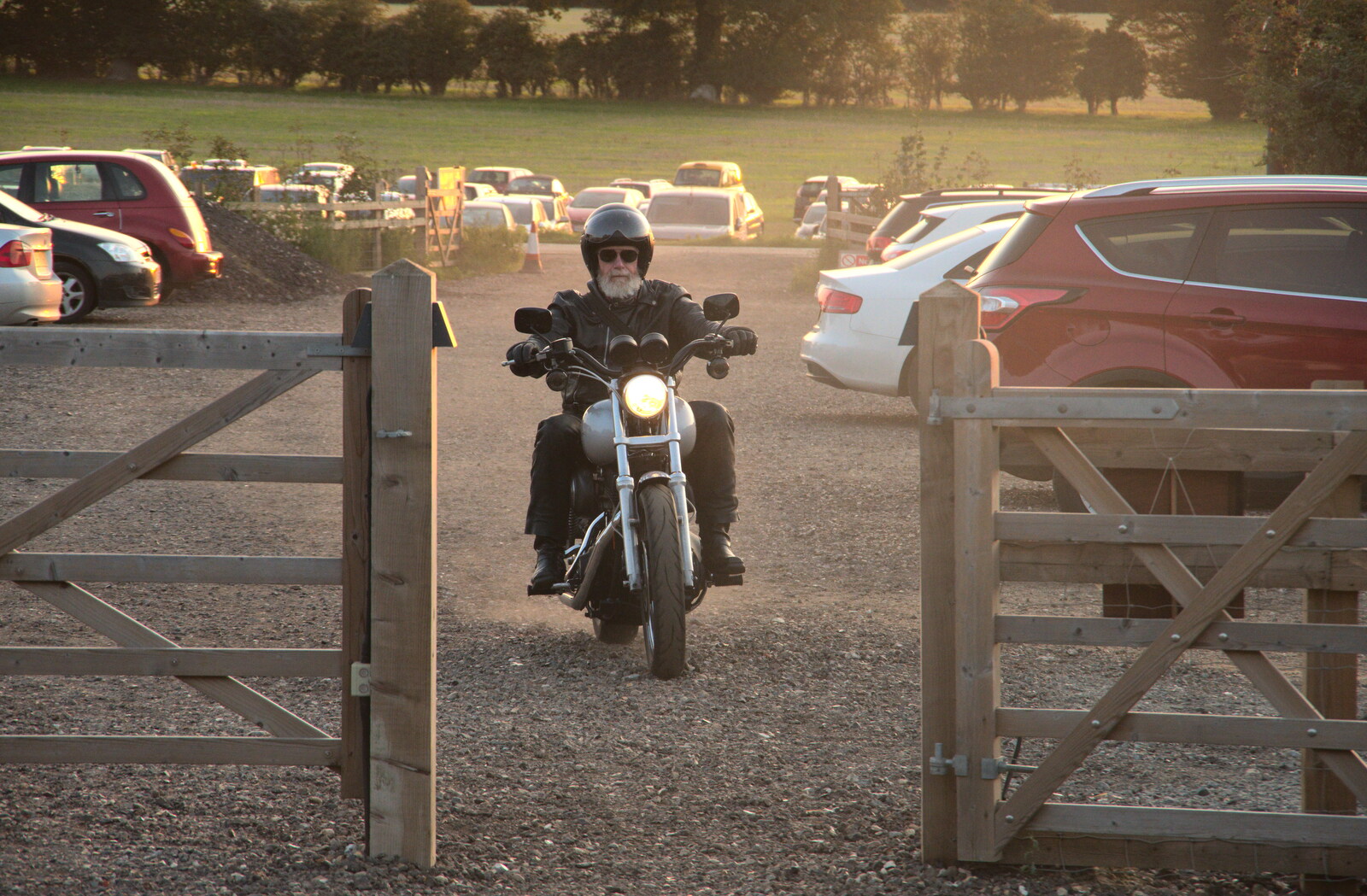 A bloke on a motorbike makes a dusty entrance from Star Wing's Hops and Hogs Festival, Redgrave, Suffolk - 12th September 2020