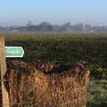 2020 A footpath sign is propped up by some bales