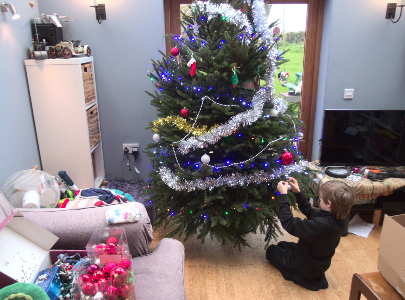 The tree is up as Harry helps to decorate from Frosty Rides and a Christmas Tree, Diss Garden Centre, Diss, Norfolk - 29th November 2020