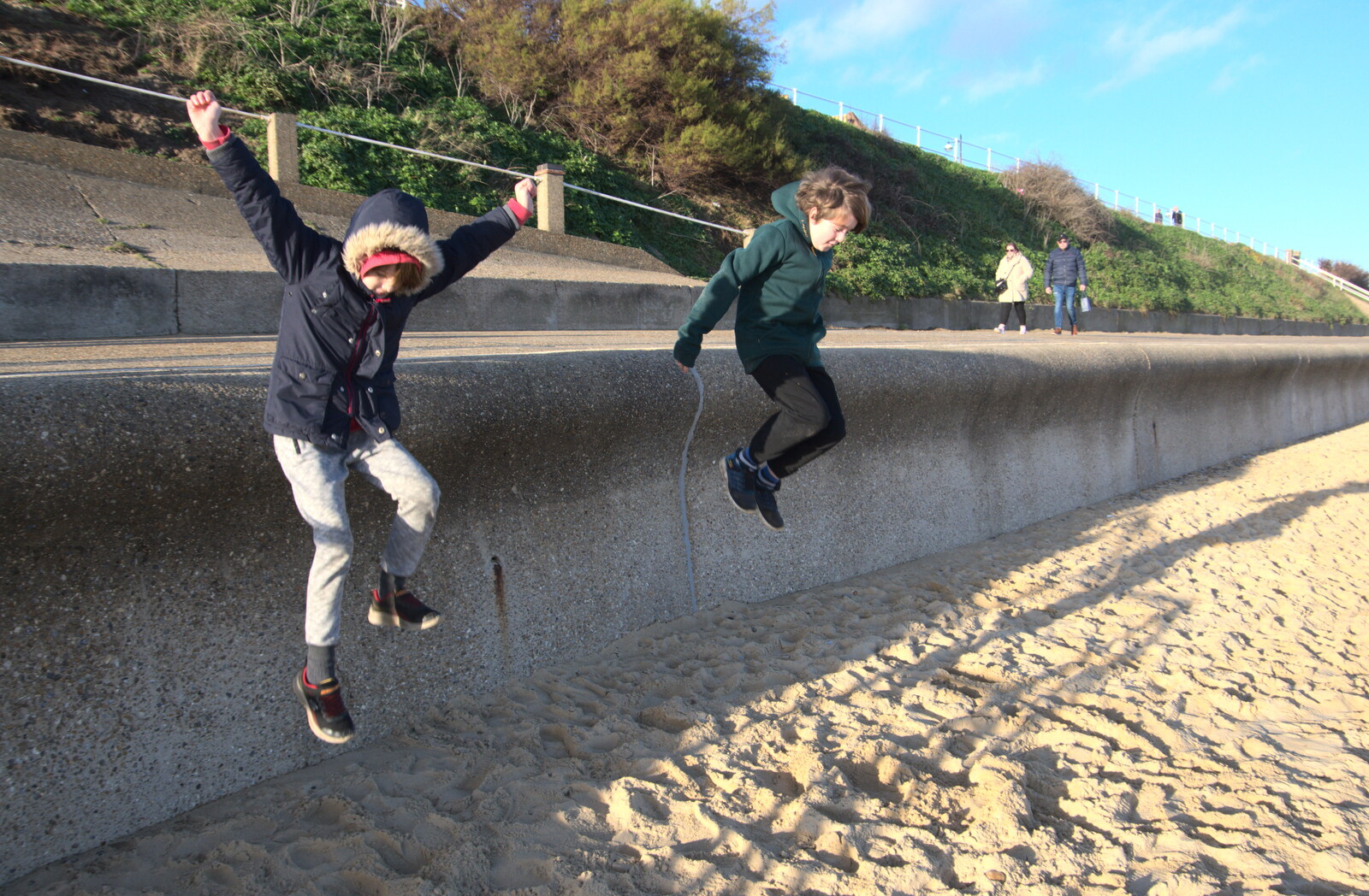 The boys leap off the sea wall from A Return to the Beach, Southwold, Suffolk - 20th December 2020