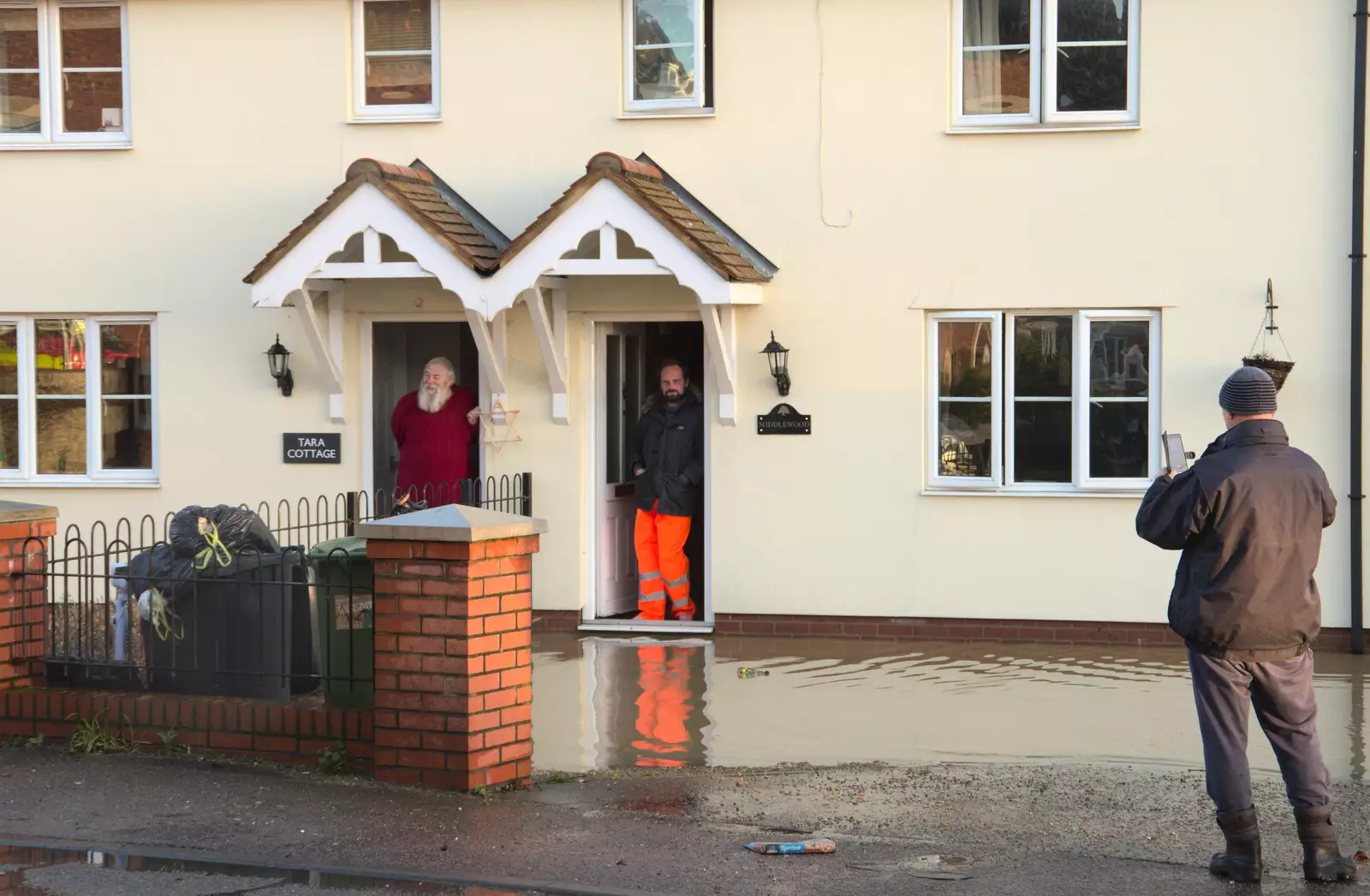 Householders look out, from The Christmas Eve Floods, Diss, Norfolk - 24th December 2020