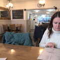 2020 Isobel checks the menu in Caféye