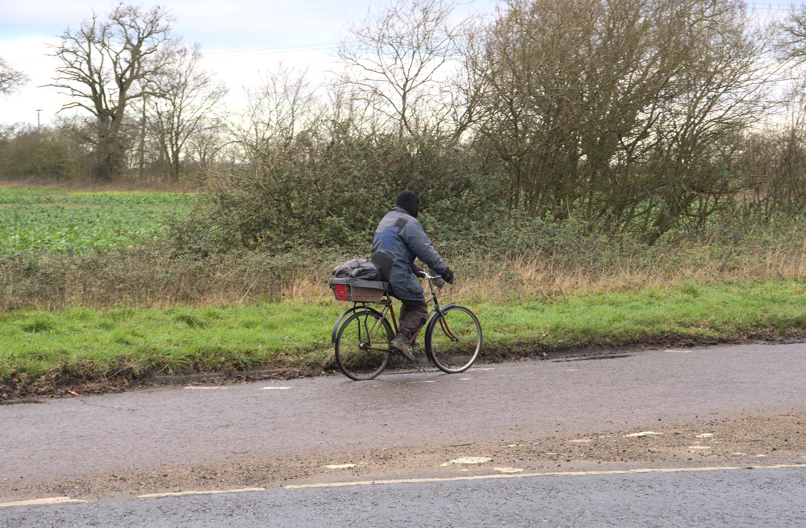 A dude on an ancient bike cycles off to Diss from A Virtual New Year's Eve, Brome, Suffolk - 31st December 2020