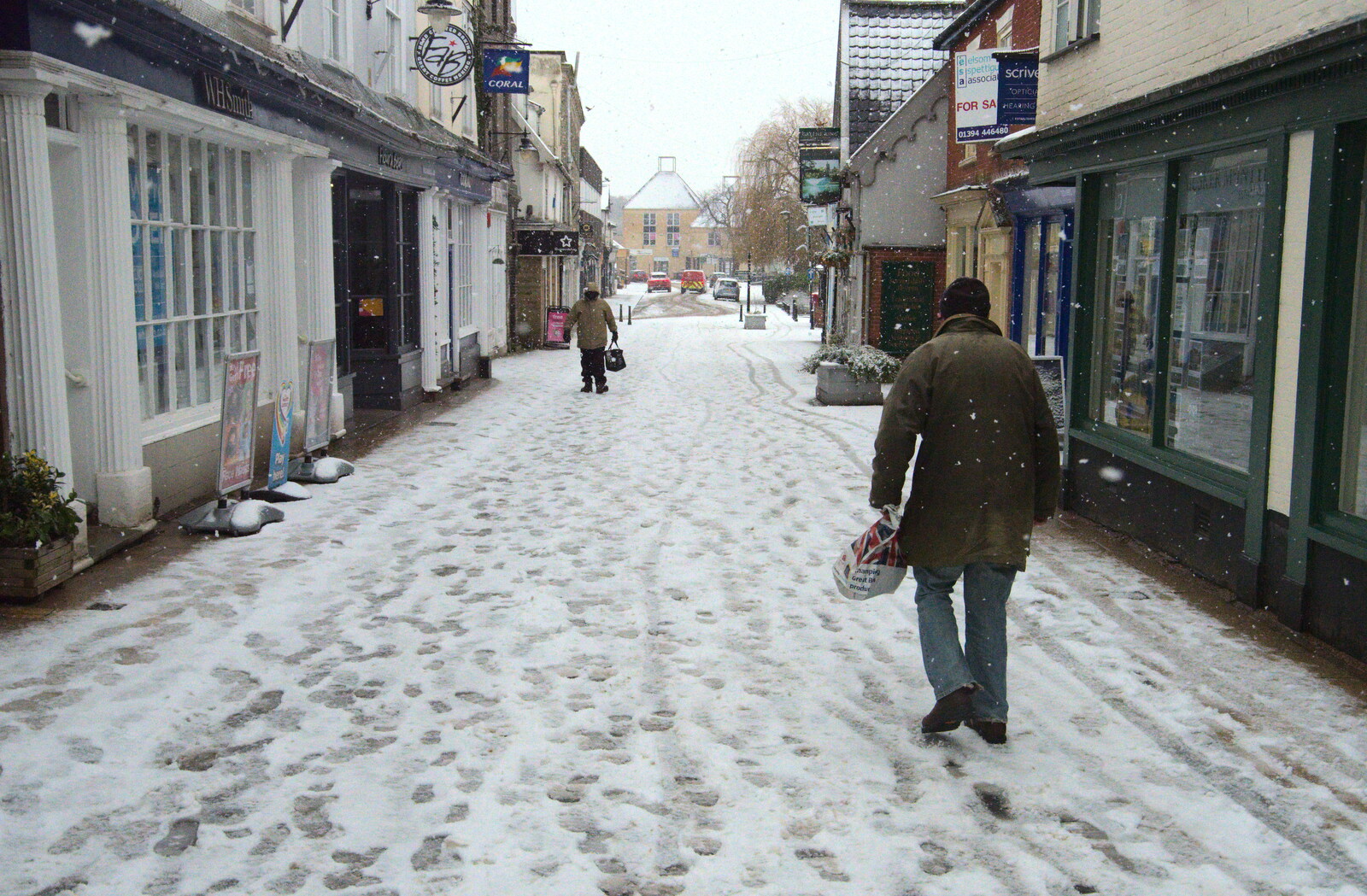 Some dude stomps past WHSmith from A Snowy Morning, Diss, Norfolk - 16th January 2021
