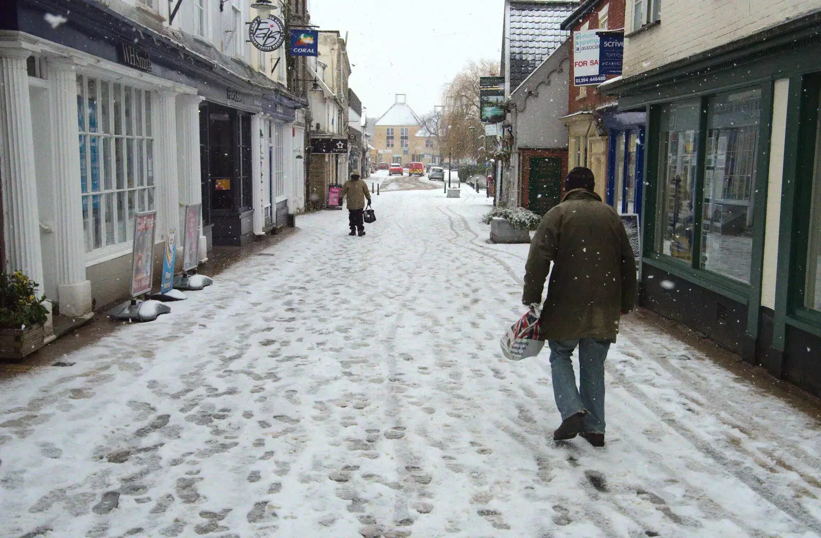 Some dude stomps past WHSmith, from A Snowy Morning, Diss, Norfolk - 16th January 2021