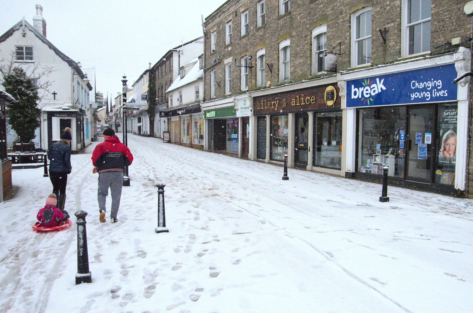 A child gets hauled up Mere Street on a sledge from A Snowy Morning, Diss, Norfolk - 16th January 2021