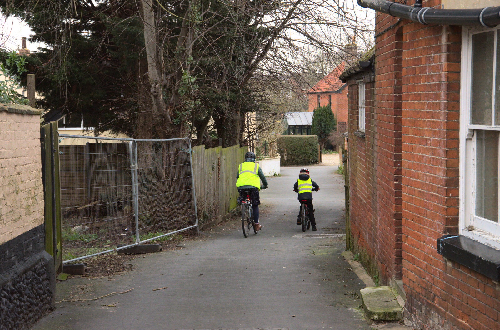Isobel and Harry ride off down Dove Lane from A Trip to the Blue Shop, Church Street, Eye, Suffolk - 2nd February 2021