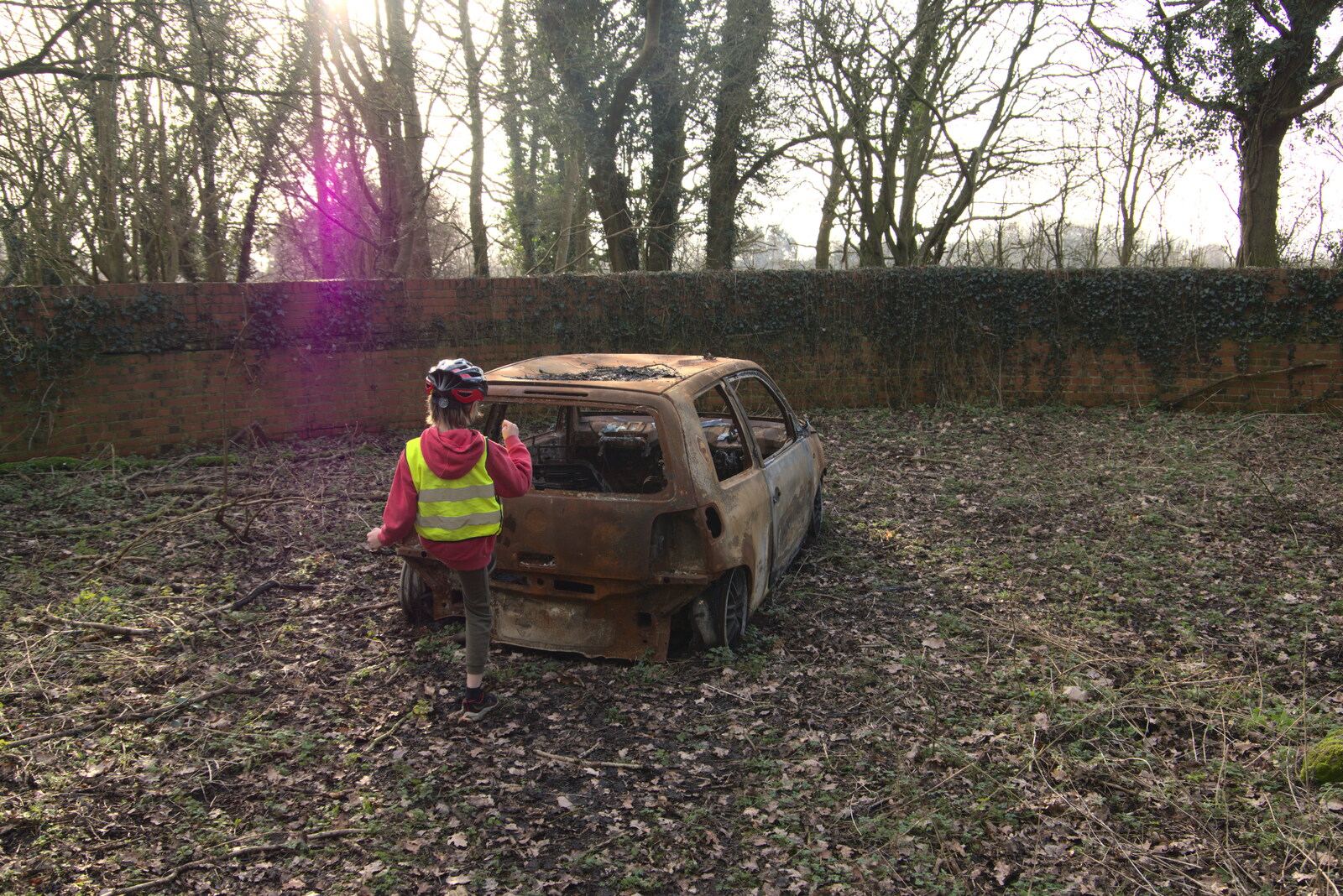 Harry kicks the burned-out car from Fred's New Bike and an A140 Closure, Brome, Suffolk - 27th February 2021