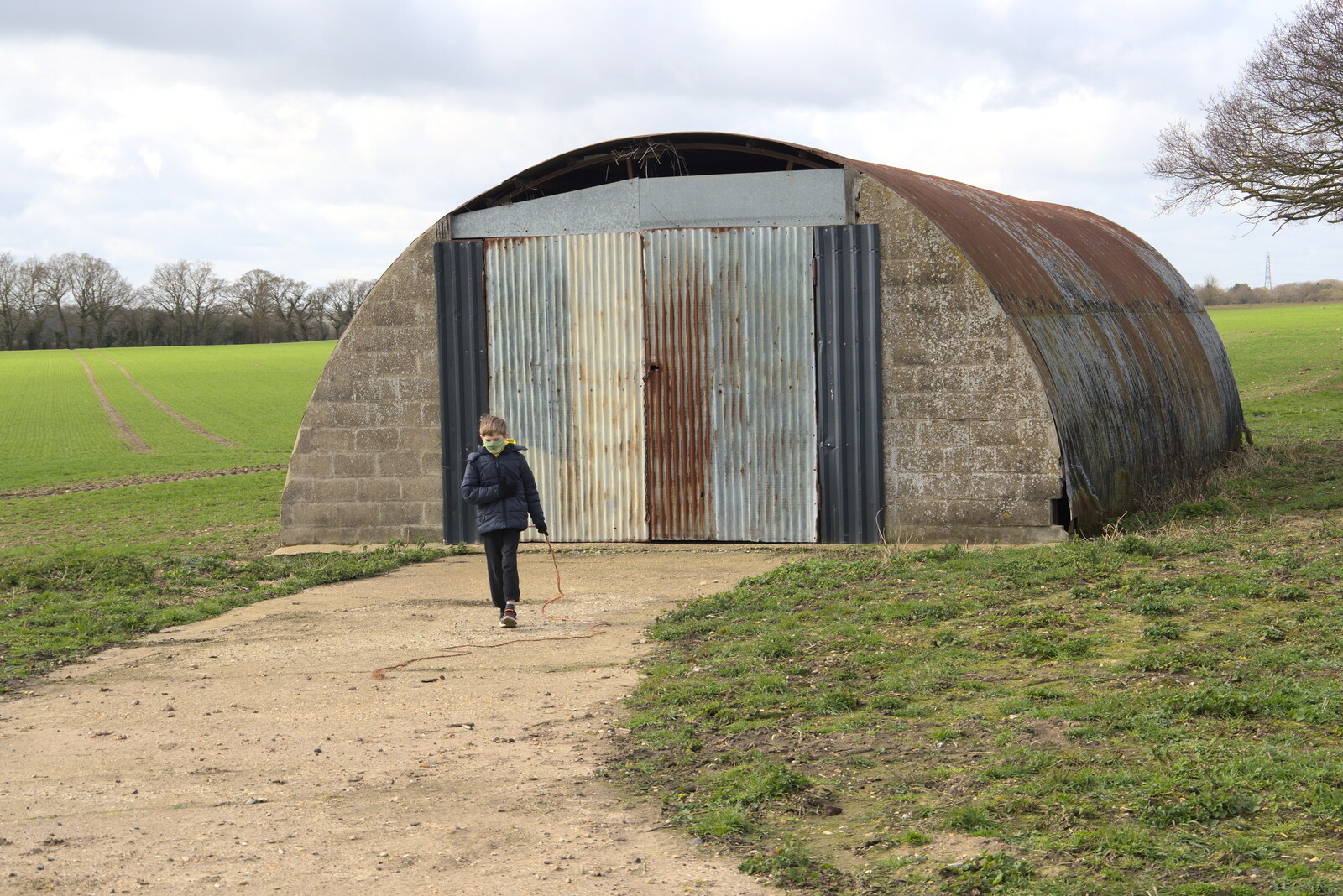 Harry walks back from the fuze store from Another Walk on Eye Airfield, Eye, Suffolk - 14th March 2021