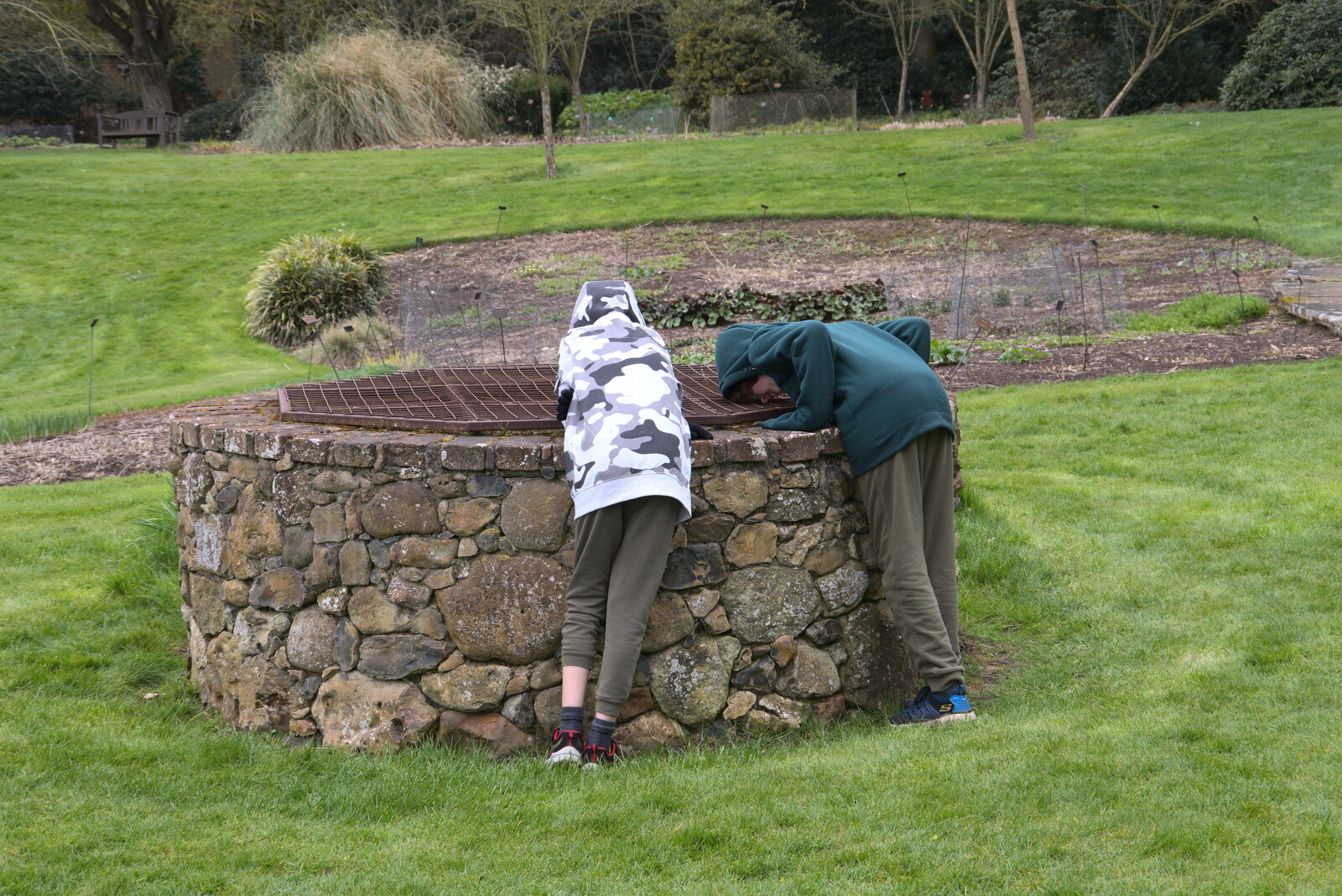 The boys look down a well from A Return to Bressingham Steam and Gardens, Bressingham, Norfolk - 28th March 2021