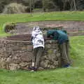 The boys look down a well, A Return to Bressingham Steam and Gardens, Bressingham, Norfolk - 28th March 2021