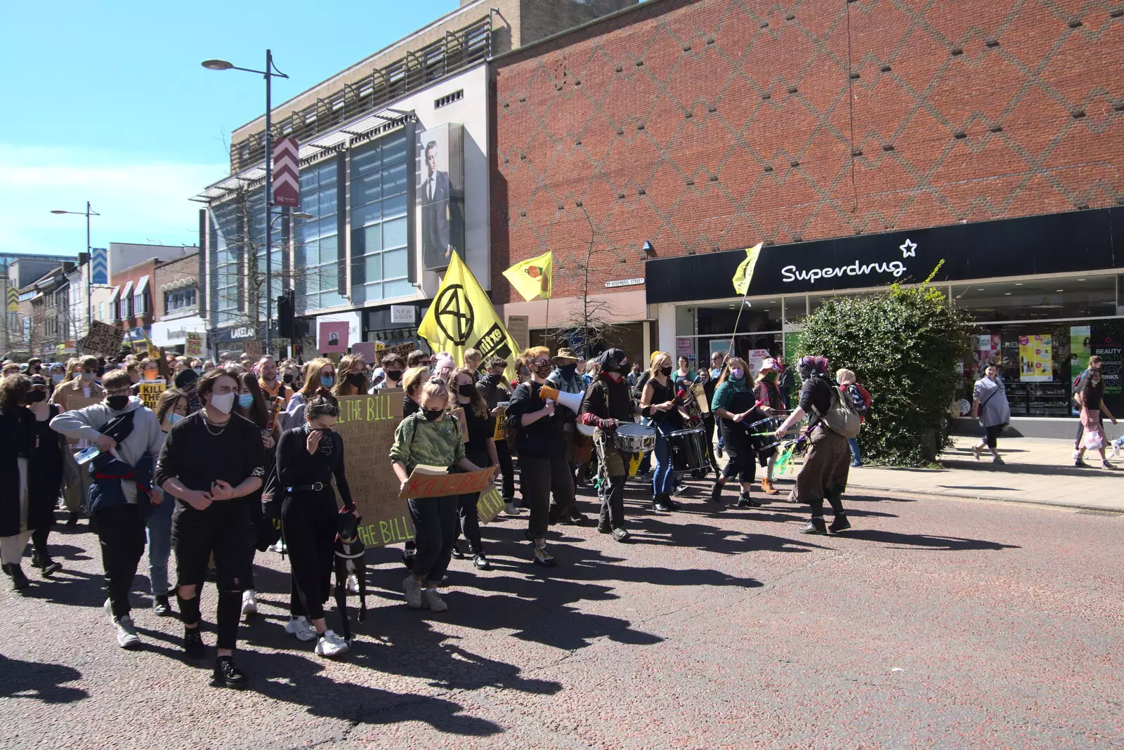 The demonstration passes by Superdrug, from The Death of Debenhams, Rampant Horse Street, Norwich, Norfolk - 17th April 2021