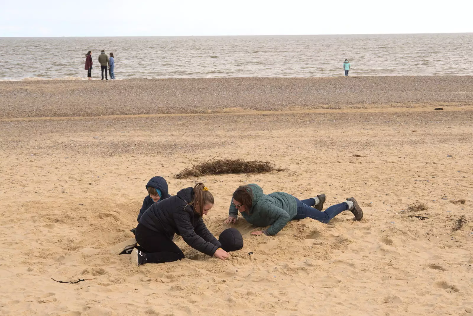 Isobel and Soph the Roph help bury Fred, from A Chilly Trip to the Beach, Southwold Harbour, Suffolk - 2nd May 2021