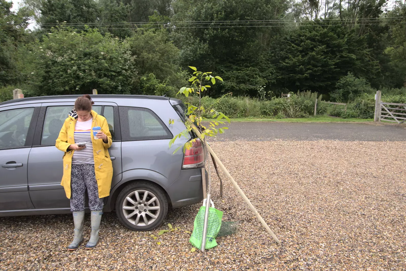 Isobel checks her phone at the skate park car park, from Planting a Tree, Town Moors, Eye, Suffolk - 10th July 2021