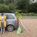 Isobel checks her phone at the skate park car park, Planting a Tree, Town Moors, Eye, Suffolk - 10th July 2021