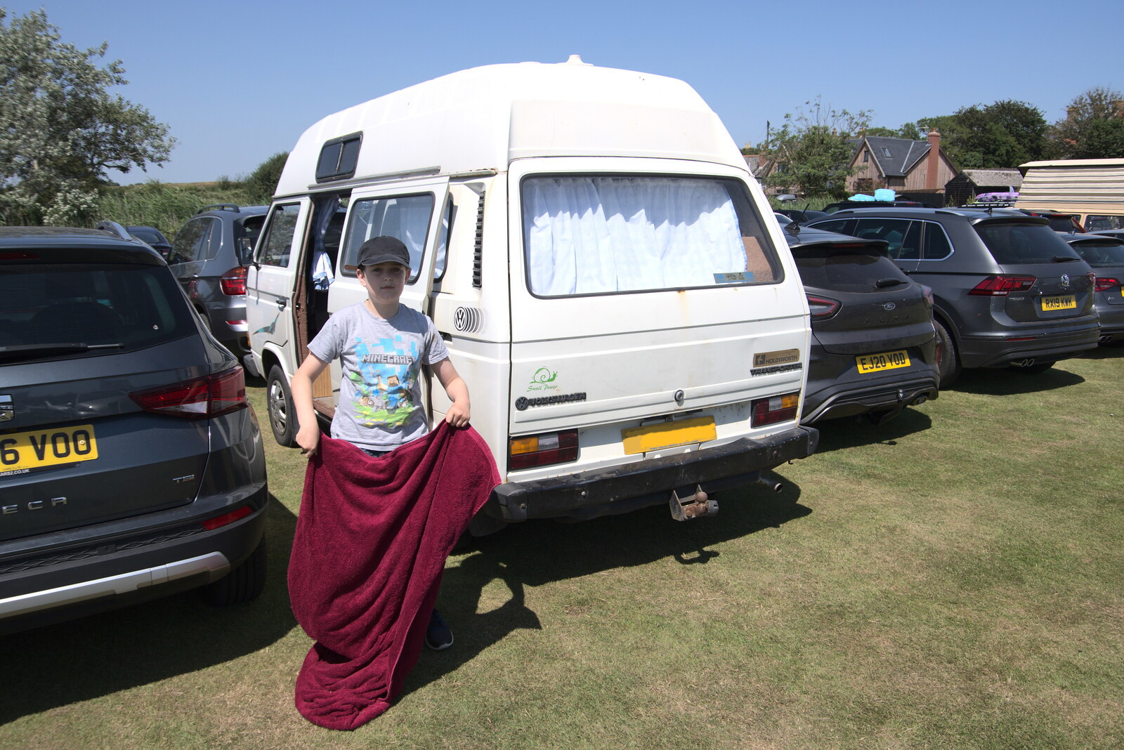 Fred shakes out a towel by the van from A Day on the Beach, Southwold, Suffolk - 18th July 2021
