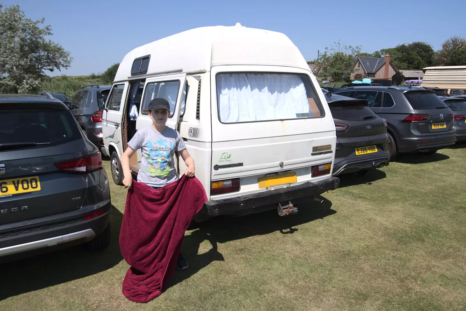 Fred shakes out a towel by the van, from A Day on the Beach, Southwold, Suffolk - 18th July 2021