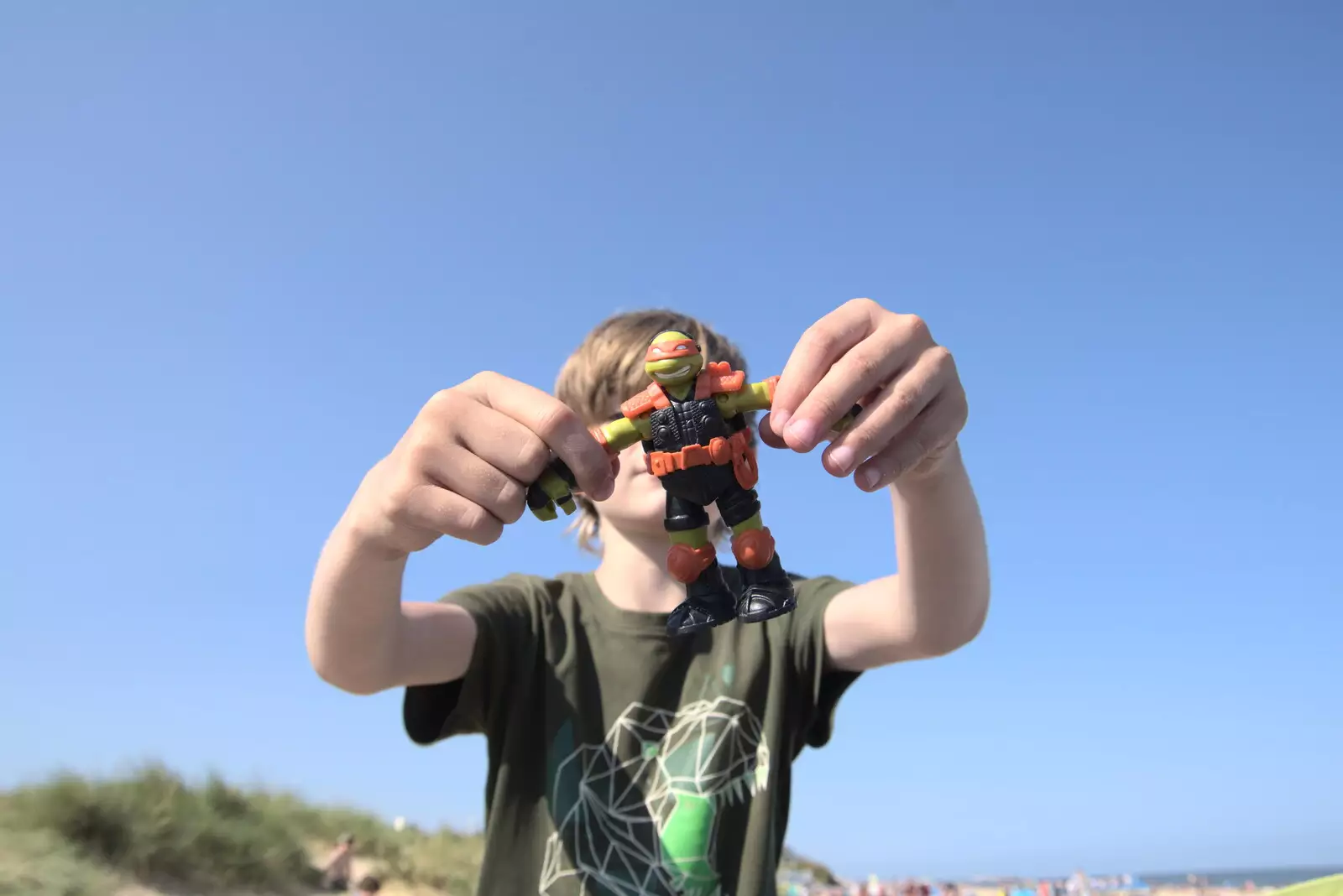 Harry shows off a Ninja Turtle he found in the sand, from A Day on the Beach, Southwold, Suffolk - 18th July 2021