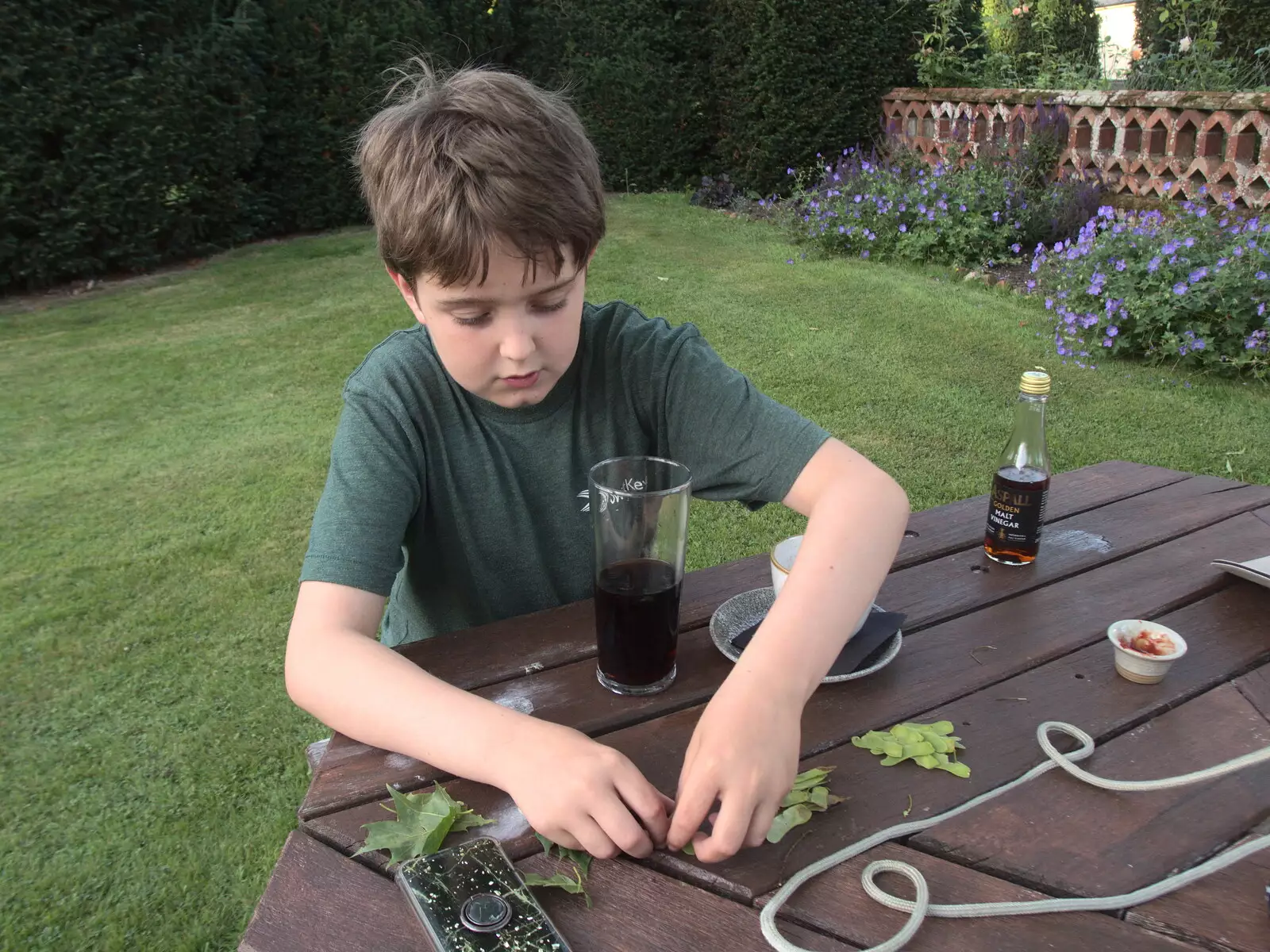 Fred assembles something out of chestnut seeds, from Hares, Tortoises and Station 119, Eye, Suffolk - 19th July 2021