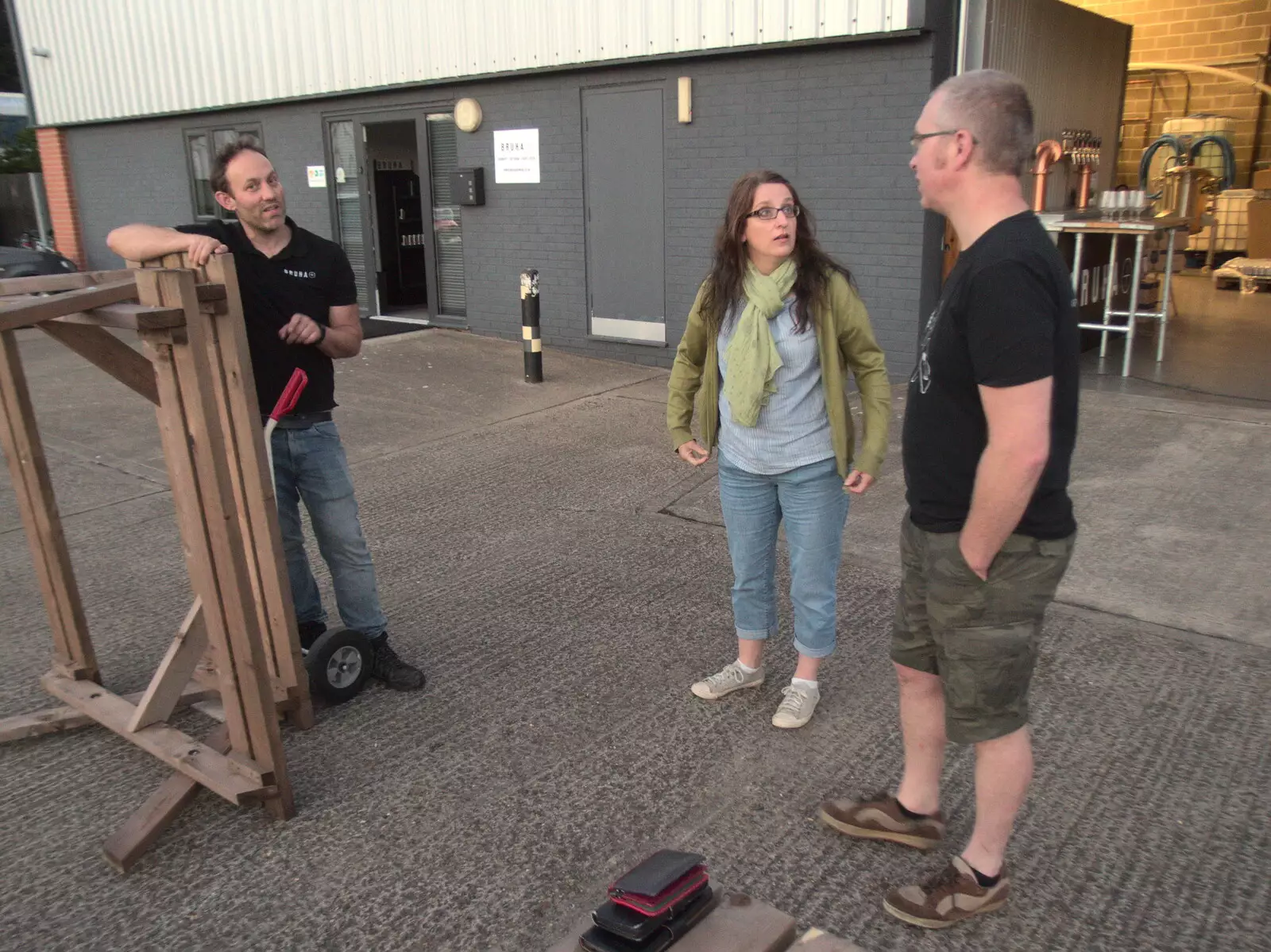 Marc stacks chairs, as Suey and Marc chat, from Hares, Tortoises and Station 119, Eye, Suffolk - 19th July 2021