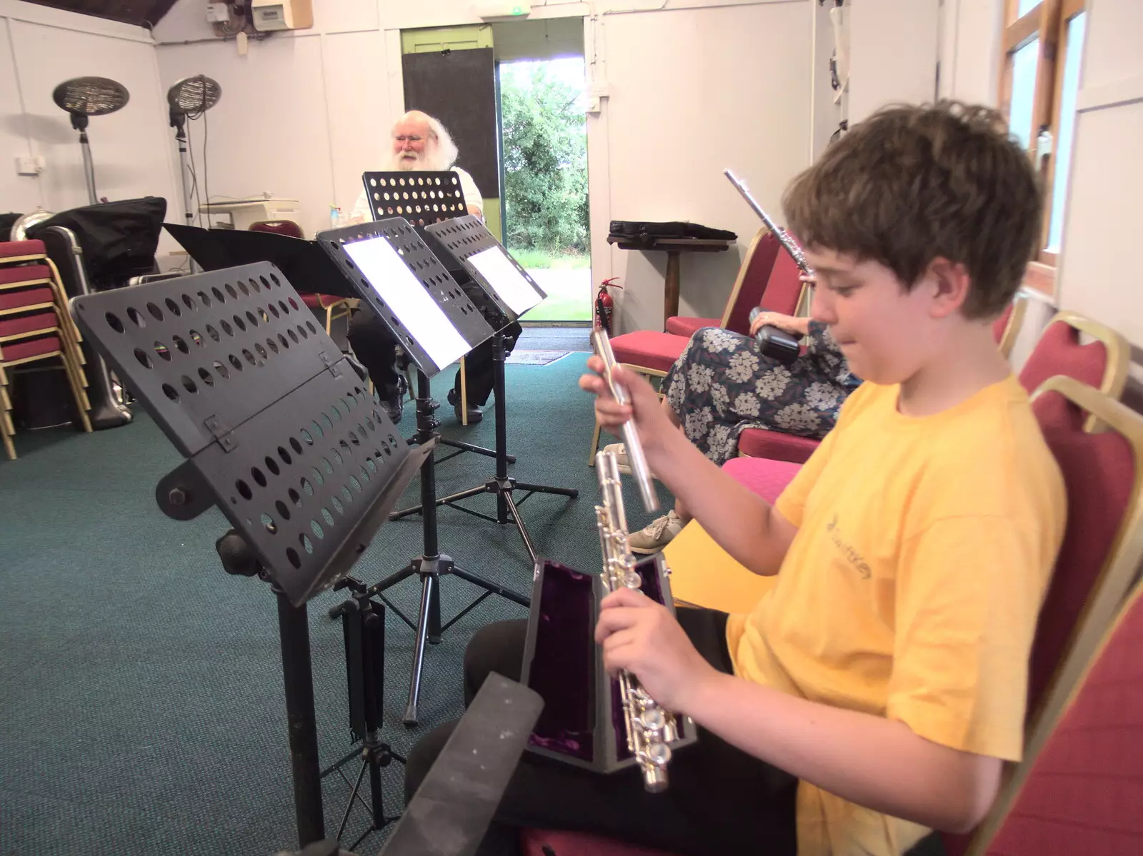 Fred assembles his flute in the band hut, from The BSCC at The Crown, Gissing, Norfolk - 22nd July 2021