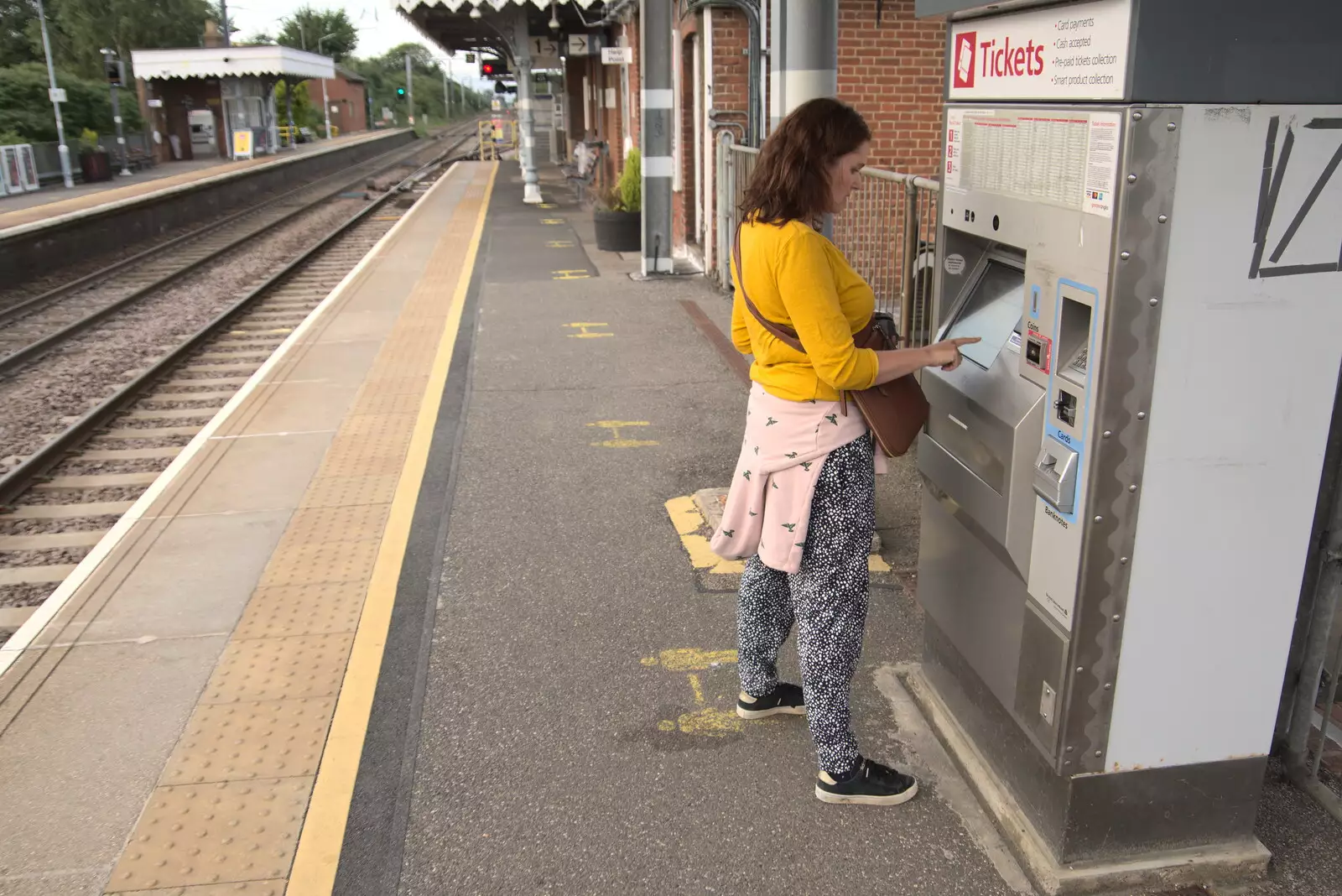 Isobel gets tickets from the machine at Diss, from A Trip to Nando's, Riverside, Norwich, Norfolk - 23rd July 2021