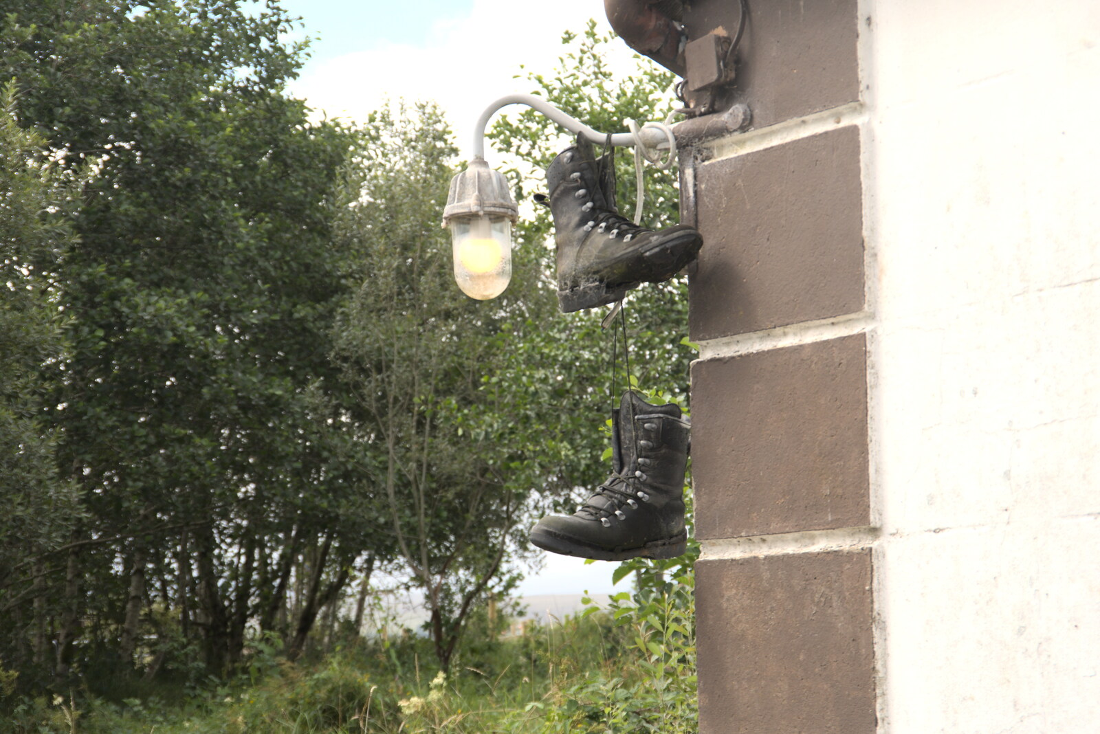Pints of Guinness and Streedagh Beach, Grange and Sligo, Ireland - 9th August 2021: A pair of boots hang up on an outside light