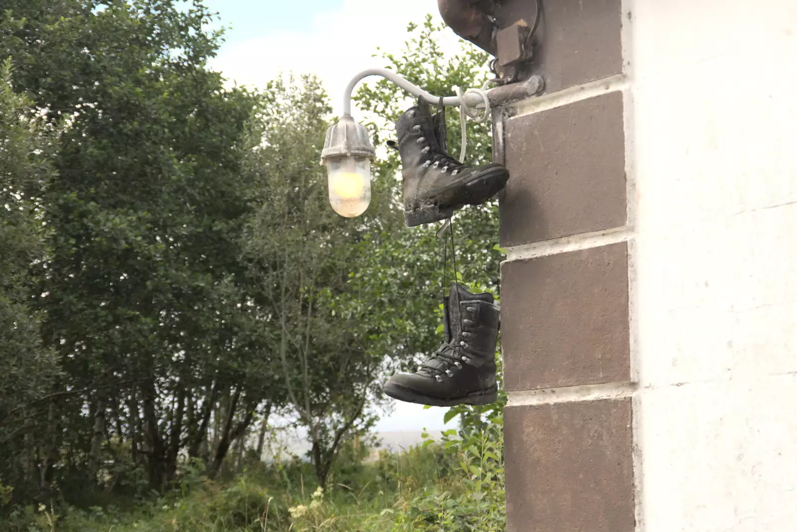 A pair of boots hang up on an outside light, from Pints of Guinness and Streedagh Beach, Grange and Sligo, Ireland - 9th August 2021