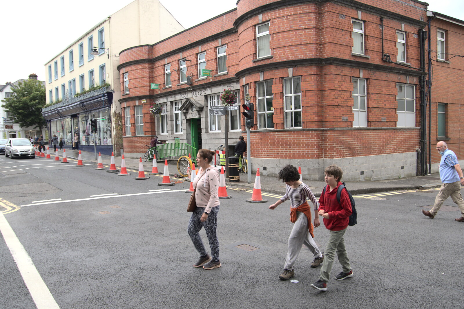 A Trip to Manorhamilton, County Leitrim, Ireland - 11th August 2021: Crossing the street by the old Post Office