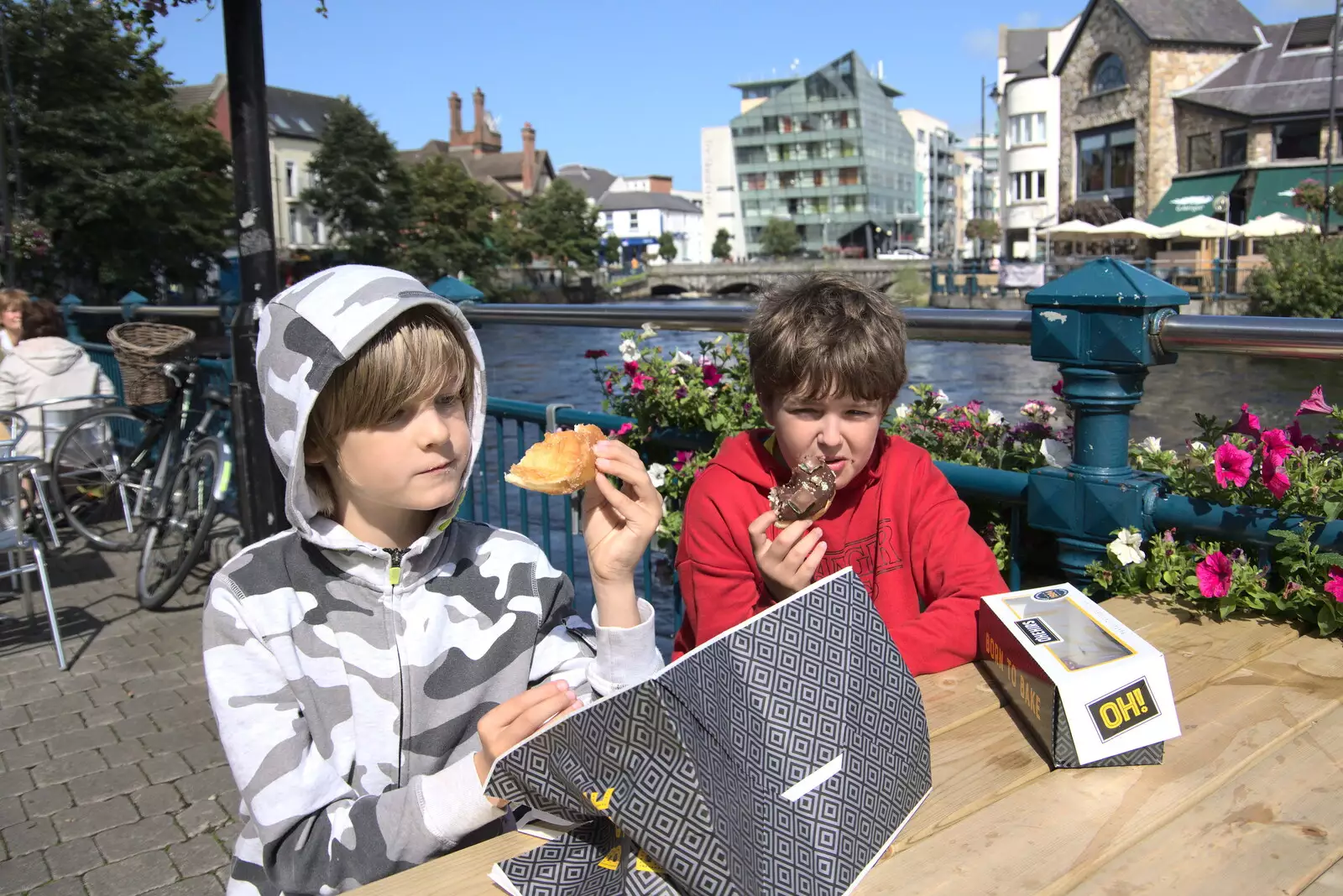 The boys scoff doughnuts by the river, from A Trip to Manorhamilton, County Leitrim, Ireland - 11th August 2021