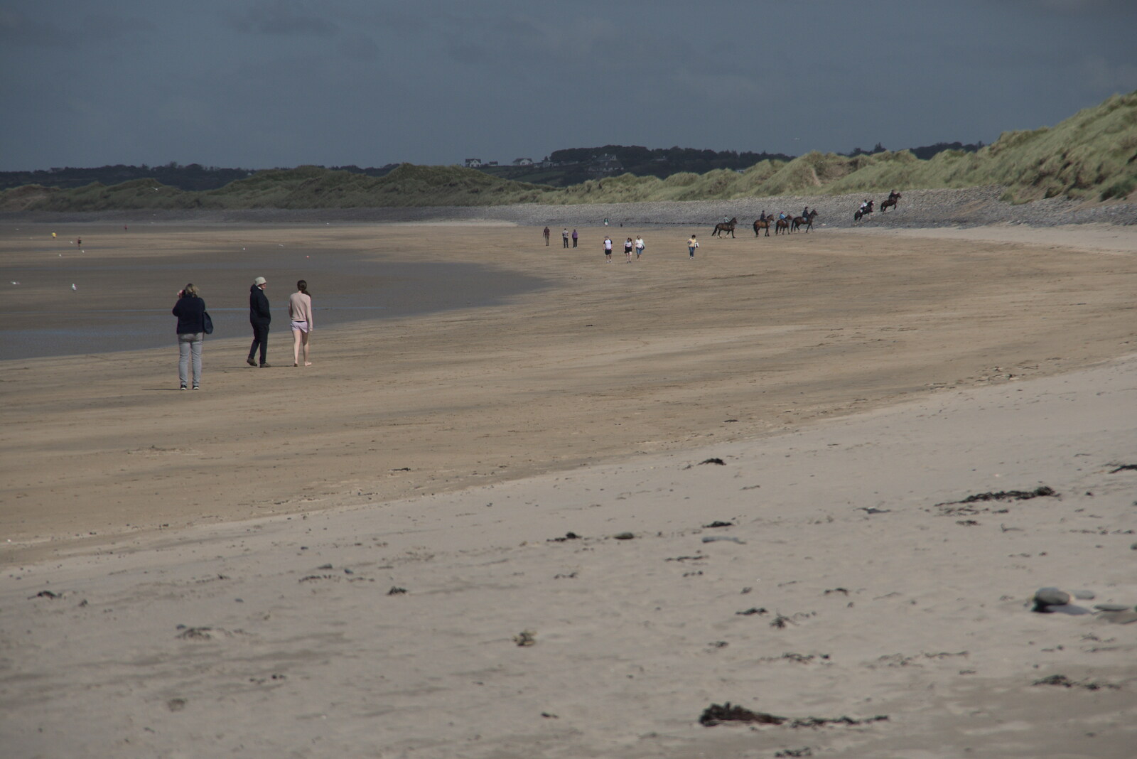A Trip to Manorhamilton, County Leitrim, Ireland - 11th August 2021: Walkers and horses on the beach