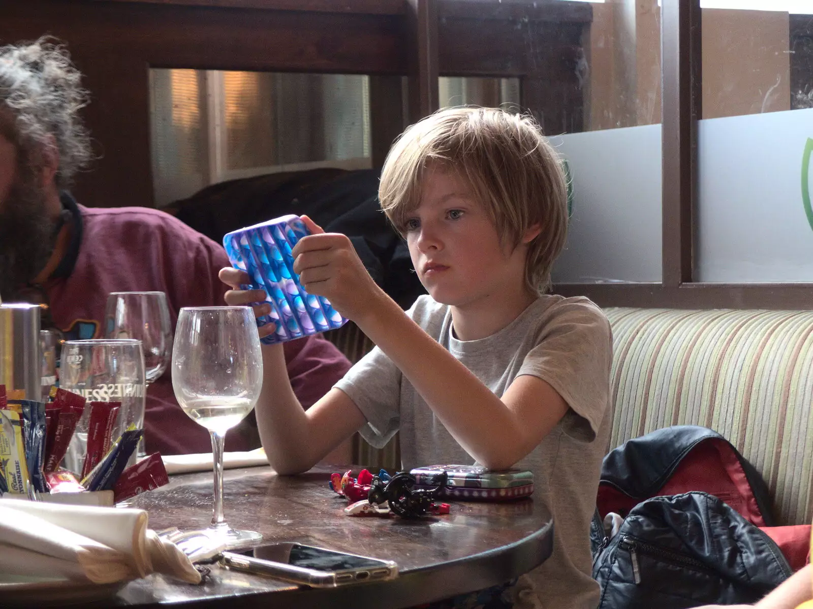 Harry considers a fidget popper, from Walks Around Benbulben and Carrowmore, County Sligo, Ireland - 13th August 2021